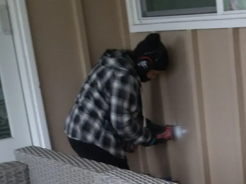 Professional electrician installing an exterior outlet in Naugatuck