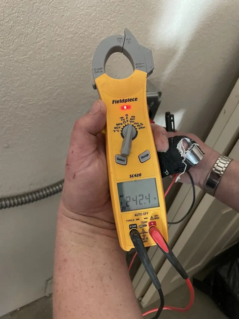 Voltage testing with clamp meter during Recessed Lighting Installation in Naugatuck